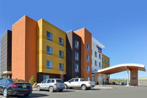 a building with cars parked in a parking lot at Fairfield Inn & Suites by Marriott Gallup in Gallup
