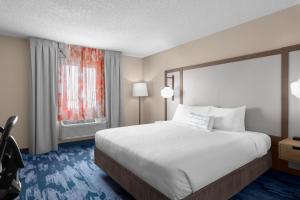 a hotel room with a bed and a window at Fairfield Inn Kennewick in Kennewick