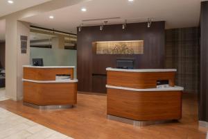 a lobby with two reception desks in a building at Courtyard by Marriott Portland Airport in Portland