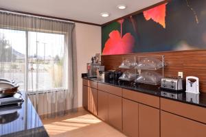a kitchen with a counter and a large window at Fairfield Inn & Suites by Marriott Helena in Helena