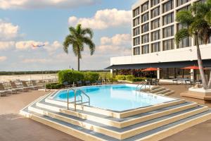 a swimming pool in front of a hotel at Tampa Airport Marriott in Tampa
