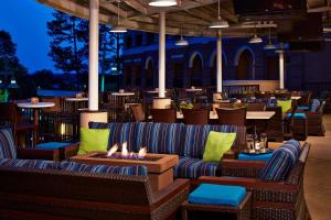 a restaurant with couches and tables and a fire pit at Marriott Shoals Hotel & Spa in Florence