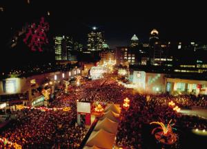 a large crowd of people on a city street at night at Fairfield Inn & Suites by Marriott Montreal Airport in Dorval