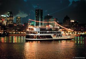a cruise ship in the water with a city at night at Fairfield Inn & Suites by Marriott Montreal Airport in Dorval