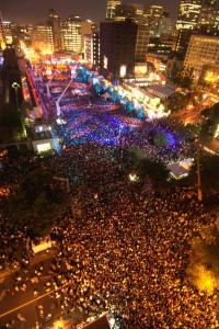 a large crowd of people on a city street at night at Fairfield Inn & Suites by Marriott Montreal Airport in Dorval