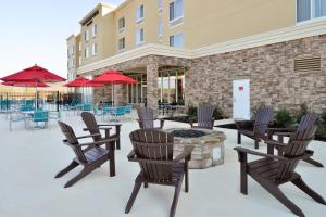 a patio with chairs and a fire pit in front of a building at TownePlace Suites by Marriott Huntsville West/Redstone Gateway in Huntsville