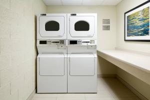 two washer and dryers in a laundry room at Fairfield Inn & Suites by Marriott Montreal Airport in Dorval