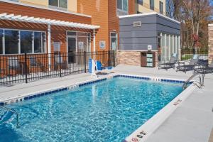 a swimming pool in front of a building at Fairfield Inn & Suites by Marriott Louisville Jeffersonville in Jeffersonville