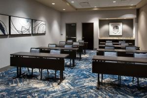 a row of tables in a room with chairs at Courtyard by Marriott Philadelphia South at The Navy Yard in Philadelphia