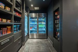 a drink aisle in a store with a drink cooler at Courtyard by Marriott Toledo West in Toledo