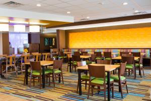 a dining room with wooden tables and chairs at Fairfield Inn & Suites by Marriott Sheridan in Sheridan