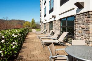 a row of chairs and tables outside of a building at SpringHill Suites by Marriott Wheeling Triadelphia Area in Wheeling