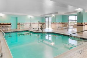 a large swimming pool in a building with blue walls at SpringHill Suites by Marriott Wheeling Triadelphia Area in Wheeling