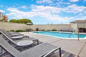 a pool with chaise lounge chairs and a swimming pool at TownePlace Suites by Marriott Sacramento Elk Grove in Elk Grove
