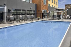 a swimming pool at a hotel with chairs and tables at Fairfield Inn & Suites by Marriott Santa Rosa Rohnert Park in Rohnert Park