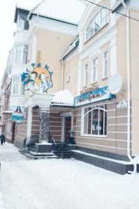 a building on a street with snow on the ground at Hotel on Dvoryanskaya in Kaluga