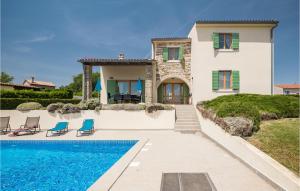 a villa with a swimming pool in front of a house at Awesome Home In Baredine With 4 Bedrooms And Outdoor Swimming Pool in Donje Baredine