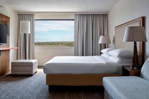 a hotel room with two beds and a large window at San Antonio Marriott Northwest Medical Center in San Antonio