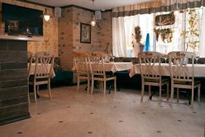 een eetkamer met een tafel en stoelen en een raam bij Hotel on Dvoryanskaya in Kaloega