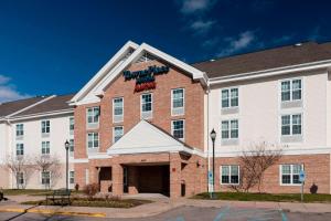 a large brick building with a sign on it at TownePlace Suites Suffolk Chesapeake in Suffolk