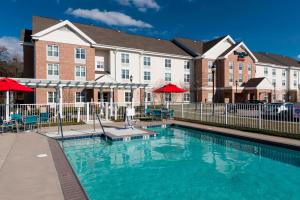 a swimming pool in front of a building at TownePlace Suites Suffolk Chesapeake in Suffolk