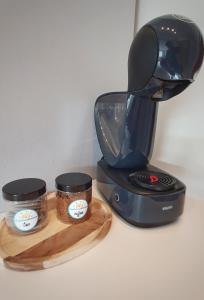 a coffee maker and two cups on a cutting board at Holiday Home Slavia New 505 widok na morze in Międzyzdroje