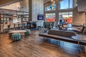 a lobby with a bar and a fireplace at Residence Inn by Marriott Tulsa Midtown in Tulsa