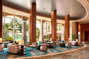 a lobby of a hotel with chairs and tables at Palm Beach Marriott Singer Island Beach Resort & Spa in Palm Beach Shores