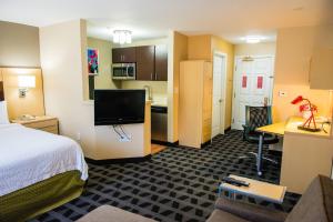 um quarto de hotel com uma cama e uma cozinha em MainStay Suites Houston NASA-Clear Lake em Webster