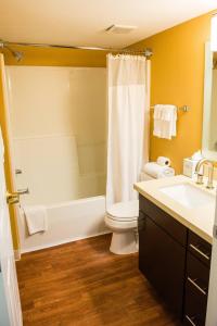 a bathroom with a shower and a toilet and a sink at MainStay Suites Houston NASA-Clear Lake in Webster