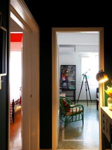 a room with a door open to a living room at MimaDart Pop-up Gallery Apartment in Piraeus