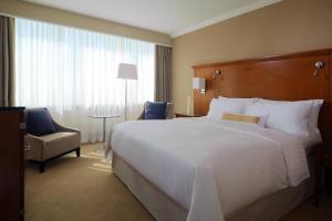 a hotel room with a large bed and a chair at Warsaw Presidential Hotel in Warsaw +37 photos
