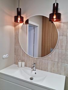 a bathroom with a sink and a mirror at Apartament Lublin Centrum "Angora Cat" in Lublin