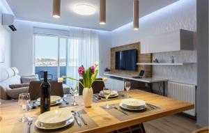 a dining room and living room with a large wooden table at Cozy Apartment In Pula With Wifi in Pula