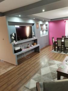 a living room with a flat screen tv on a wall at Apartament u Wioli in Okleśna +39 photos