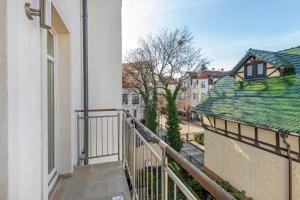 an apartment balcony with a view of a street at Willa Morska Deluxe by Grand Apartments in Sopot