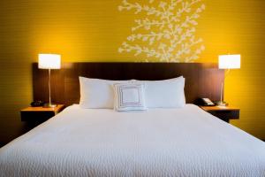 a bedroom with a large bed with two lamps on both sides at Fairfield Inn & Suites by Marriott Fort Walton Beach-West Destin in Fort Walton Beach