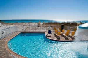 a swimming pool with chairs and a fountain at Fairfield Inn & Suites by Marriott Fort Walton Beach-West Destin in Fort Walton Beach