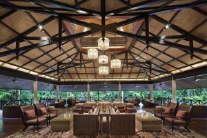 a large room with tables and chairs and chandeliers at Mulu Marriott Resort in Mulu