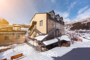 a house in the snow with snow covered stairs at Popock Tsaghkadzor in Tsaghkadzor