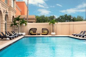 einen Pool mit Liegestühlen neben einem Gebäude in der Unterkunft Renaissance Tampa International Plaza Hotel in Tampa