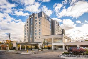 a building with a car parked in front of it at Delta Hotels by Marriott Waterloo in Waterloo