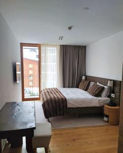 Postel nebo postele na pokoji v ubytování Gotthard Hotel Apartment