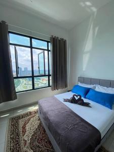 a bedroom with a large bed with a large window at CheeAyu@ Putrajaya IOI Resort in Putrajaya