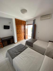 Posteľ alebo postele v izbe v ubytovaní Hotel Simón