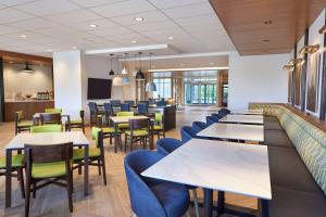 a restaurant with tables and chairs and a bar at Fairfield by Marriott Inn & Suites Orillia in Orillia