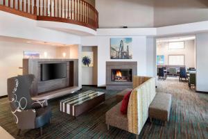 a living room with a fireplace and a tv at Residence Inn by Marriott Santa Clarita Valencia in Santa Clarita