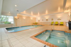 a pool in a building with two swimming pools at SpringHill Suites Grand Forks in Grand Forks
