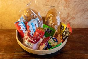 a basket filled with different types of snacks at Art Rooms Joyful People in Alberobello