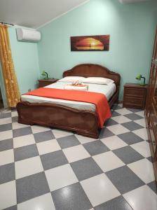 a bedroom with a bed and a checkered floor at Casa Vacanza via Annarita Sidoti in Porto San Giorgio